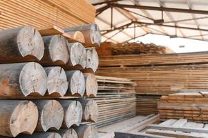 Round timber logs for building wooden house. Removing bark from logs using a machine. Pattern of logs. Woodworking factory. Lumber Industry photo