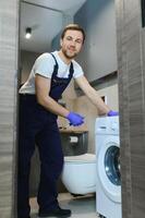 Technician repairing a washing machine photo