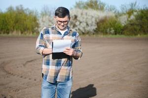 Portrait of senior farmer with glasses in field photo