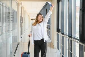 Happy woman traveling and walking in airport photo
