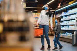 Mother and son in face mask in shopping mall photo