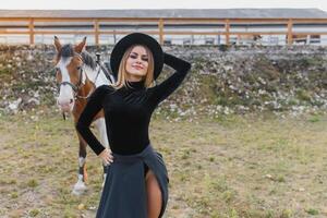 Beautiful glamour woman with a horse photo