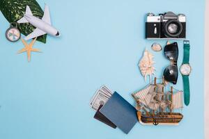 Travel accessories on blue background, travel concept. Top view with copy space photo