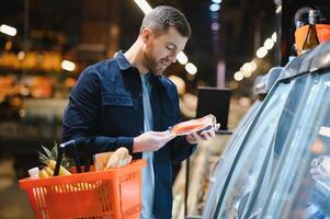 Man shopping in a supermarket photo