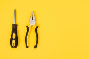 Carpenter tools set on yellow background, top view photo