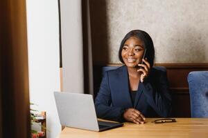 happy young african american businesswoman using computer in office photo
