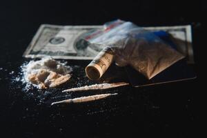 Cocaine and money isolated on black background. photo