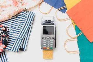 Close up of hand using credit card swiping machine to pay. credit card payment through a shopping terminal. Credit card payment for new clothing collection photo