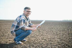 A farmer checks quality of soil before sowing. photo