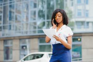 business black woman holding a cup of coffee and files photo