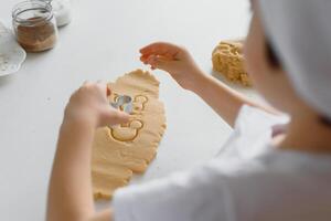 Happy family in the kitchen. Mother and son preparing cookies. photo