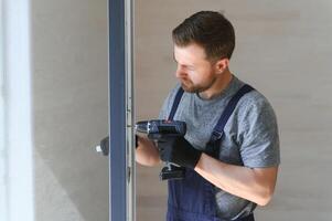 A worker installs windows in a new modular home. The concept of a new home. photo