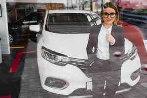 business woman buys a car at a car dealership photo