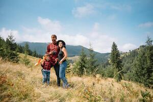 Father and child hiking in scenic mountains. Dad and son enjoying the view from the mountain top in Carpathian mountains. photo