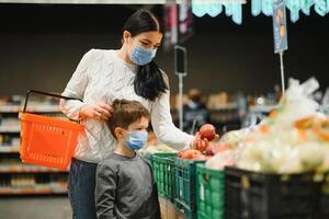 Mother and son in face mask in shopping mall photo