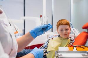 Female dentist and child in a dentist office photo