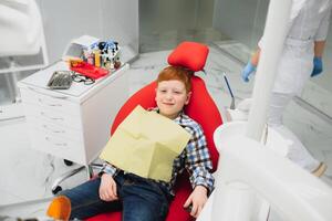 Female dentist and child in a dentist office photo