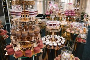 Delicious wedding reception candy bar dessert table. macaroon on candy bar, candy bar on holiday, candy bar at the wedding. photo