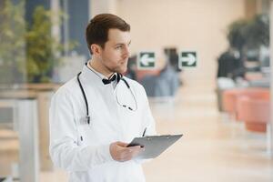 Male Doctor stands in the hall of the hospital photo