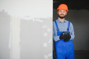 Workers install a plasterboard wall. photo