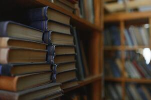 old books on shelves in archive blurred image, library photo