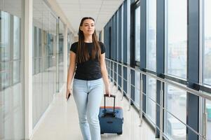 pretty woman waiting for her flight at airport photo