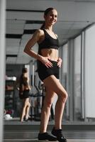 Sports. Woman at the gym doing stretching exercises. photo