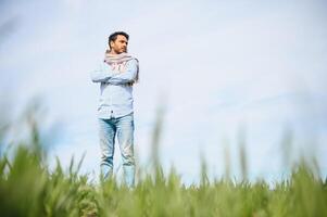 worry less ,indian farmer standing in his healthy wheat field photo