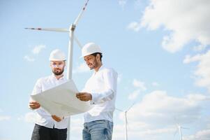 dos asiático ingenieros masculino comprobación viento turbinas renovable energía tecnología y sostenibilidad. alternativa energía para futuro. foto