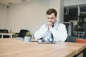 Praying for a successful operation. Cropped shot of a handsome male doctor praying. photo