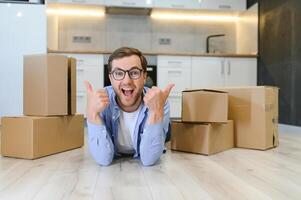 Happy man with cardboard box in new home photo