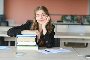 education and school concept - student girl studying and reading book at school. photo