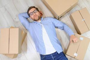 Happy man with cardboard box in new home photo
