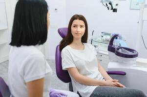 Dentist and patient in dentist office photo