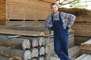 Joiner in uniform check boards on timber mill photo