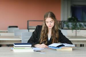 education and school concept - student girl studying and reading book at school. photo