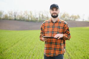 Portrait of farmer standing in field. photo