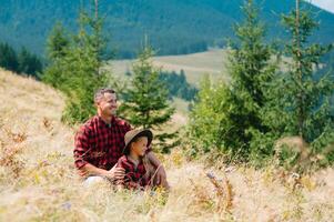 Happy father and little child are walking in the mountains. Father's Day. vacation in the national park photo