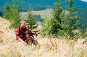 Happy father and little child are walking in the mountains. Father's Day. vacation in the national park photo