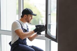 trabajador de la construcción instalando ventana en casa foto