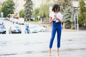 business black woman holding a cup of coffee and files photo