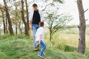 Happy time with father. Family fun concept. Bearded man and cute son Kids smile. Spring time walk with father. photo