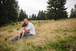 Happy father and little child are walking in the mountains. Father's Day. vacation in the national park photo