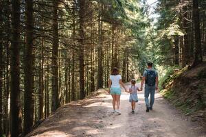 Young family with child resting on a forest photo