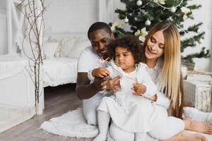 happy multiracial family with gifts at Christmas photo