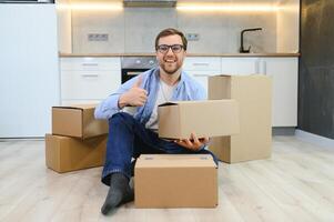 Smiling guy moving into his new home photo