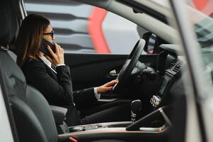 Young business woman driving in her car to work. Successful business concept. business woman driving photo