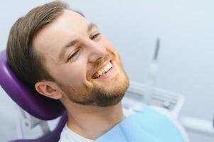 Dental care concept. Handsome young guy at the dentist's office. photo