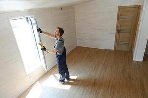 Process of construction new and modern modular house from composite sip panels. Worker man in special protective uniform wear working on building development industry of energy efficient property. photo