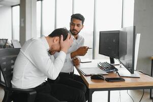 Two diverse crypto traders brokers stock exchange market investors discussing trading charts research reports growth using pc computer looking at screen analyzing invest strategy, financial risks. photo